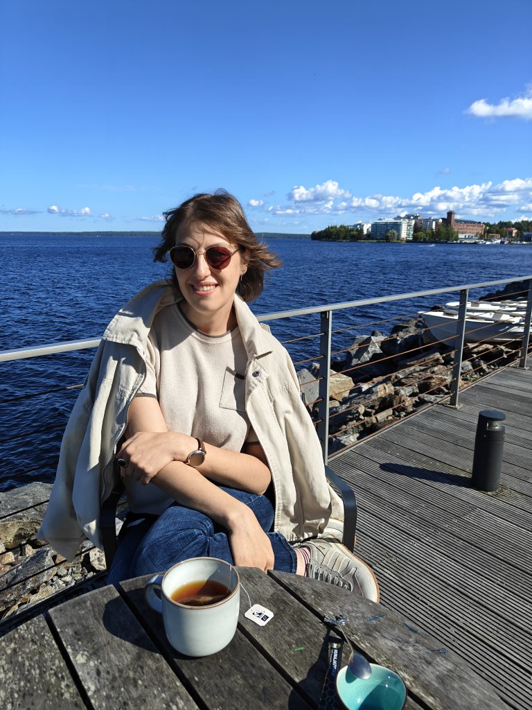 Woman is sitting looking to camera